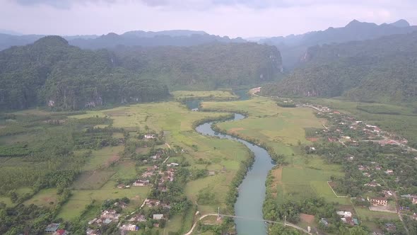 Blue Calm River Between Town Parts Connected By White Bridge