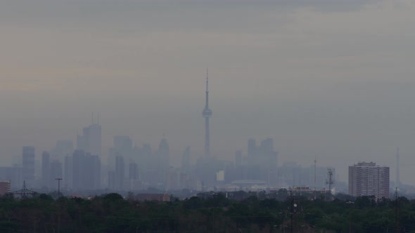 Toronto skyline shrouded by grey fog. Time-lapse.