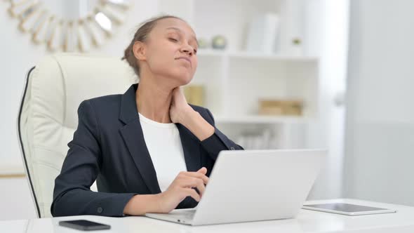 Tired African Businesswoman with Laptop Having Neck Pain in Office 