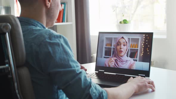 Young male entrepreneur works at home office at the computer.