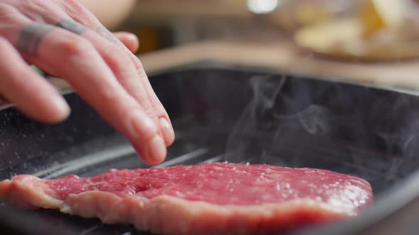 Preparing Beef Steak on Grill Pan