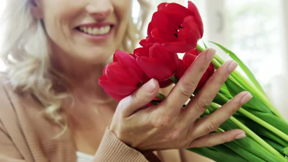 Woman smelling bouquet of flowers