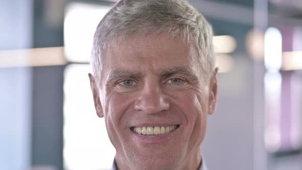 Close Up of Cheerful Middle Aged Man Smiling at Camera