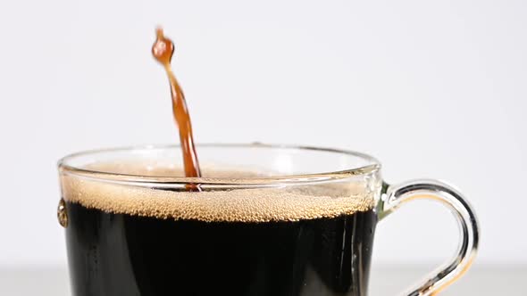 Throwing brown sugar cubes in cup of black coffee