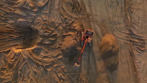 Excavator at Work Leveling the Surface with Sand at a Construction Site Top View