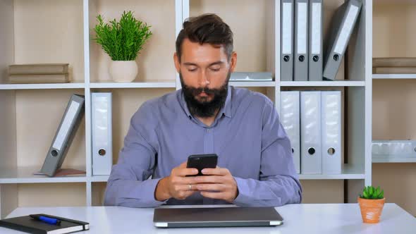 Happy Employer Use Mobile in Workspace