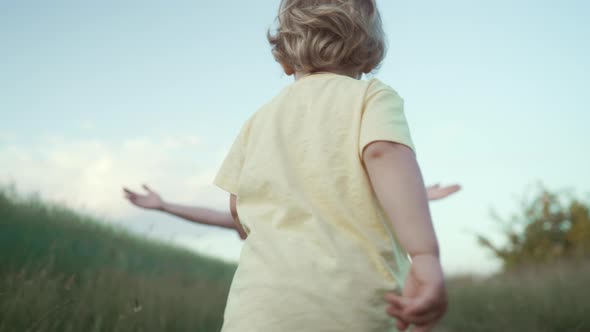 Cute Little Boy Happily Runs to Arms of His Mother