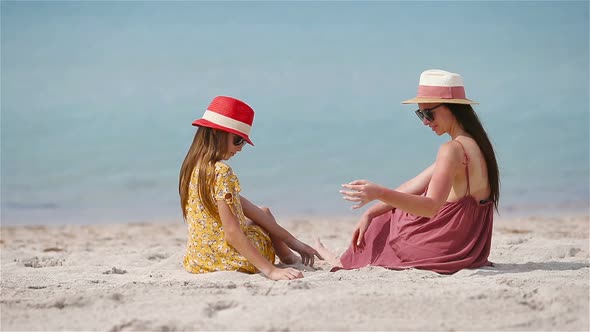 Beautiful Mother and Daughter at Caribbean Beach Enjoying Summer Vacation.