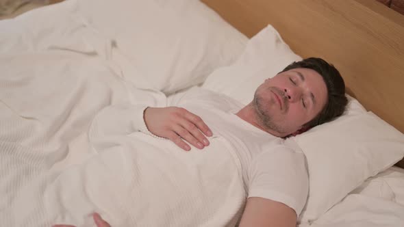 Middle Aged Man Sleeping in Bed Peacefully