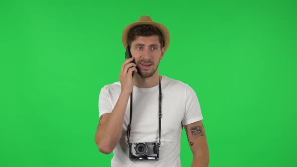 Portrait of Confident Guy Is Talking for Mobile Phone. Green Screen