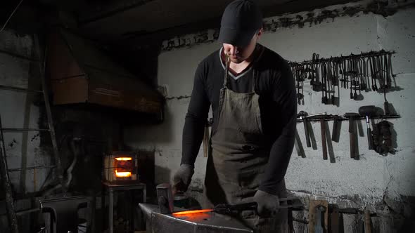 A Man Blacksmith Working with a Hot Metal