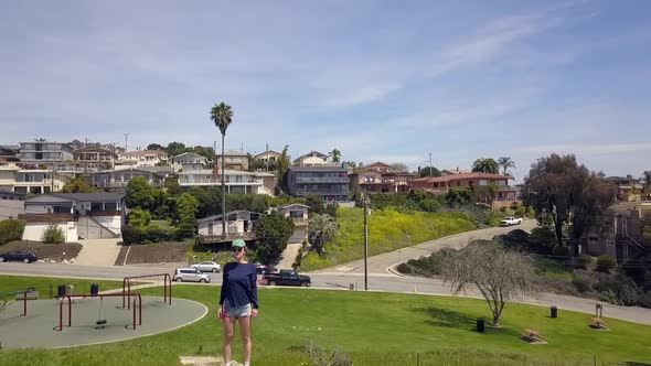 Lonely woman with hotpants stands on rocks Wonderful aerial view flight Very close passing flight d