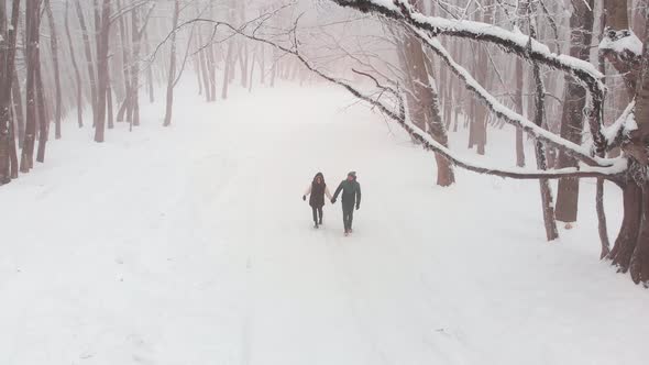 Front View Couple Walking In Winter Forest