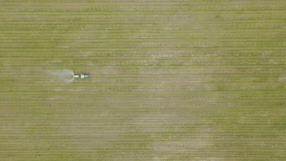 An Aerial View of a Tractor Spraying a Farmers Apple Crop In