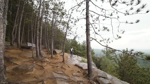 Female hiker walking on mountain slope