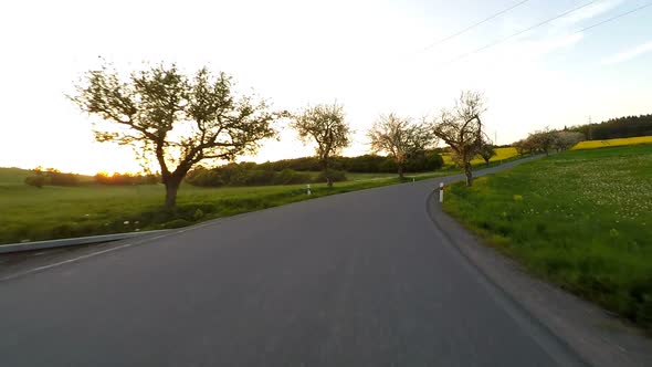 Car driving in spring time in rural countryside