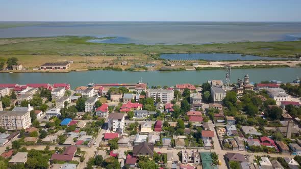 Aerial View Of Sulina City Harbor And The Danube Flowing Into The Black Sea