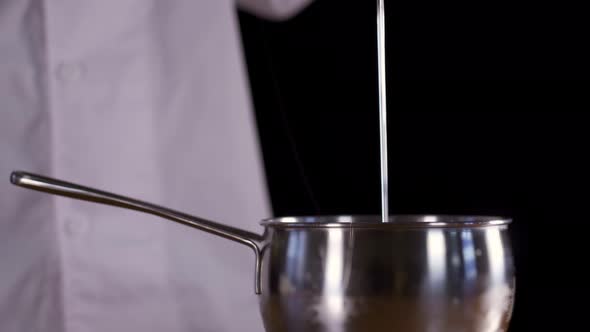 Transparent Cream is Poured Into a Metal Pan