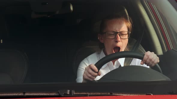 Sleepy Woman Driving a Car