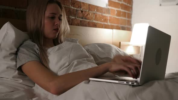 Angry Frustrated Woman Working Online at Night in Bed