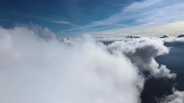 Aerial View From Airplane Window at High Altitude of Earth Covered with Puffy Cumulus Clouds Forming