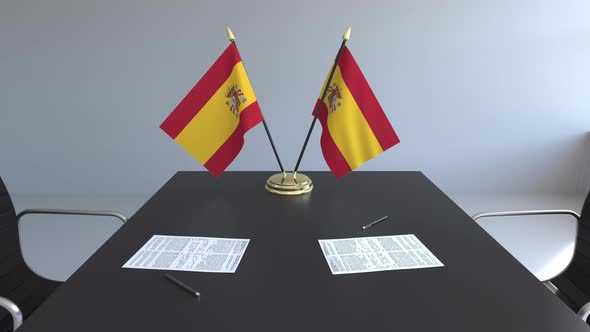 Flags of Spain and Papers on the Table