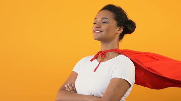 Self-Confident Afro-American Woman With Crossed Hands in Red Cape, Super Hero