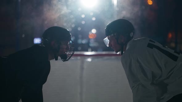 Slow Motion Competitions Hockey Players in Protective Gear Look at Each Other Steam Coming From the