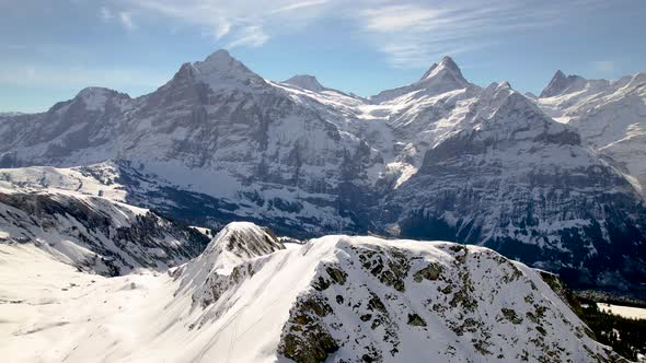 clockwise orbit around a snowboarder on a snowy mountain top in Swiss Alps