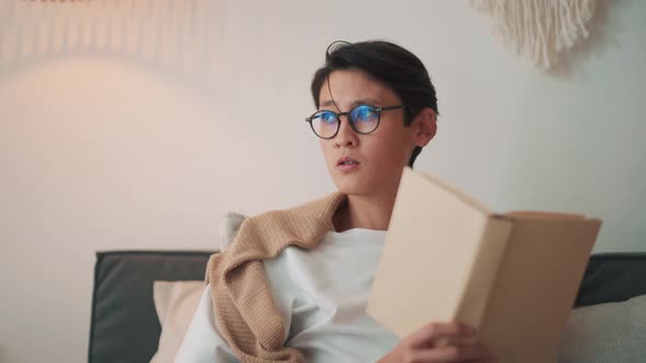 Concentrated Asian man reading book