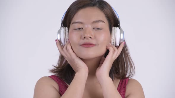 Face of Young Asian Tourist Woman Listening To Music