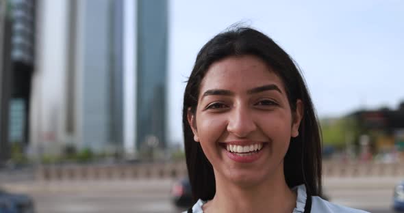 Indian business woman working outside of the office with city in background