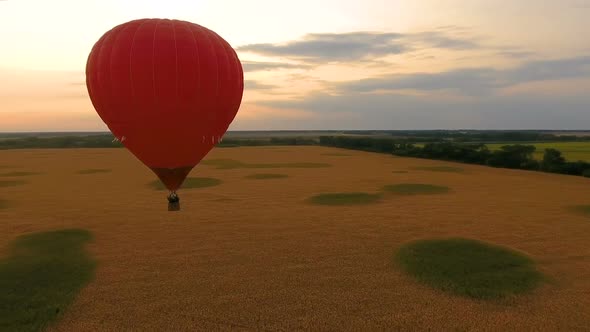 Red Hot Air Balloon Floating Over Field at Sunset, Romantic Anniversary, Love