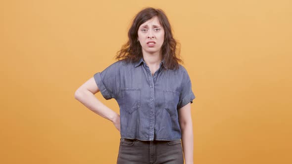 Young Woman Over Yelloe Background Looks Unsure and Anxious