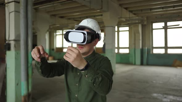 An Engineer Wearing Virtual Reality Glasses Moves Digital Objects with His Hands