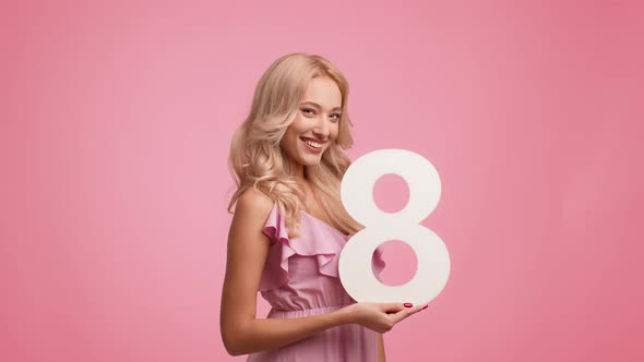 Lady Holding Number Eight Winking Eye Celebrating Holiday Pink Background