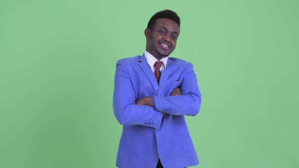 Happy Young African Businessman Smiling with Arms Crossed