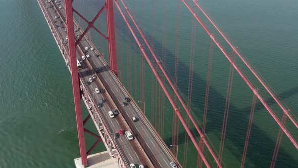 Aerial Slider Front View of Dense Multi Vehicle Traffic Across Famous Large Red Suspension Ponte 25