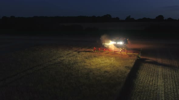 Night Time Harvest Using a Large Combine Harvester in a Field