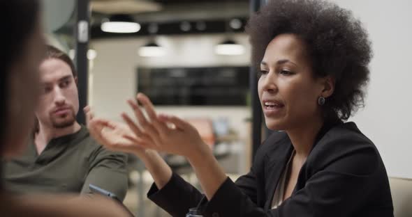 Black Businesswoman Discussing Data with Coworkers