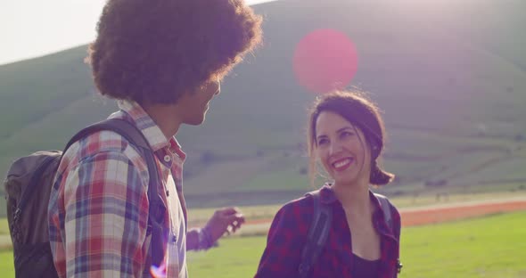 Man and Woman Smiling and Laughing on a Field Together Outdoor at sunset.Slow Motion close-up.Loving