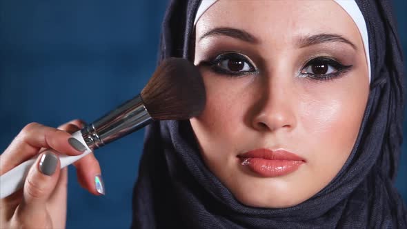 Close Up Shot of the Portrait of Muslim Woman, Who Is Powdered with a Brush