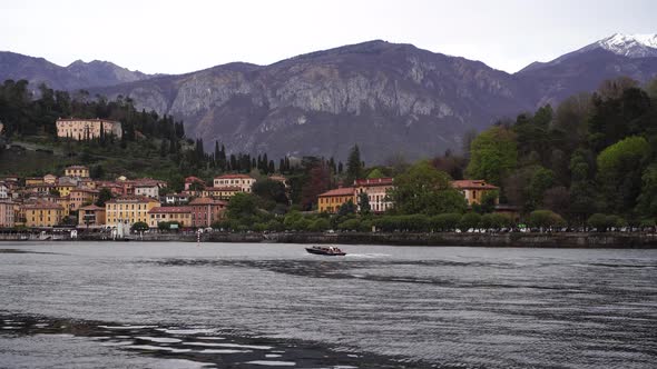 Colored Houses on the Shore of Lake Como Surrounded By Forest