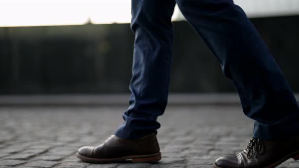 Walk in Empty City in Morning Closeup of Male Legs with Pants and Shoes Stepping on Pavement