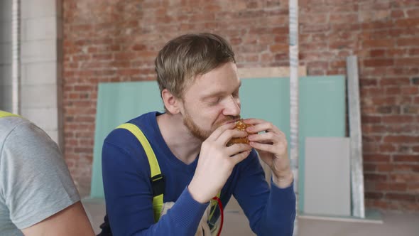Worker Wearing Uniform Eating Burger During Lunch Break alt