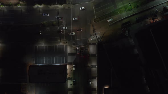 Aerial Birds Eye Overhead Top Down View of Cars Driving Through Intersection