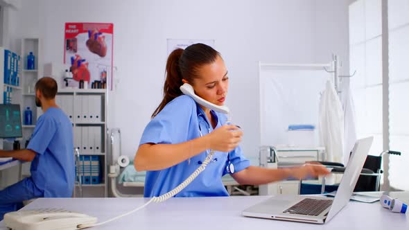 Nurse Answering at Hospital Call Checking the Result of Patient Xray