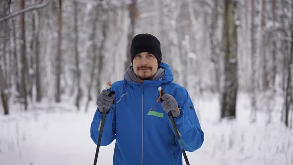 Portrait of an Attractive Man in the Winter Forest