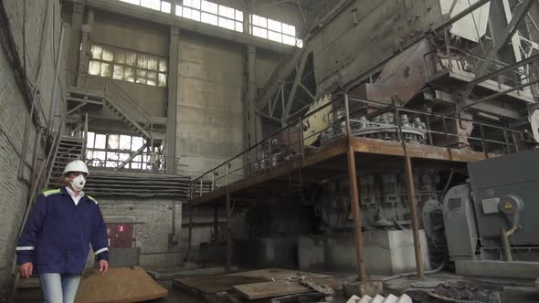 Engineer Wearing a White Helmet Oversees Industrial Granite Processing Slow Motion