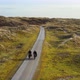 Man and woman riding bikes on dirt road, Nes, Friesland, Netherlands - VideoHive Item for Sale